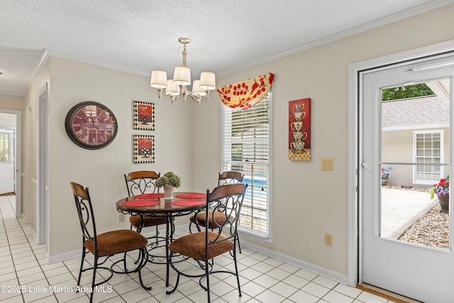 970 Raintree Dr, Alexander City, AL 35010 - dining room with crown molding, a chandelier, a textured ceiling, and light tile patterned flooring