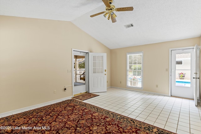 970 Raintree Dr, Alexander City, AL 35010 - foyer with ceiling fan, lofted ceiling, light tile patterned floors, and a textured ceiling