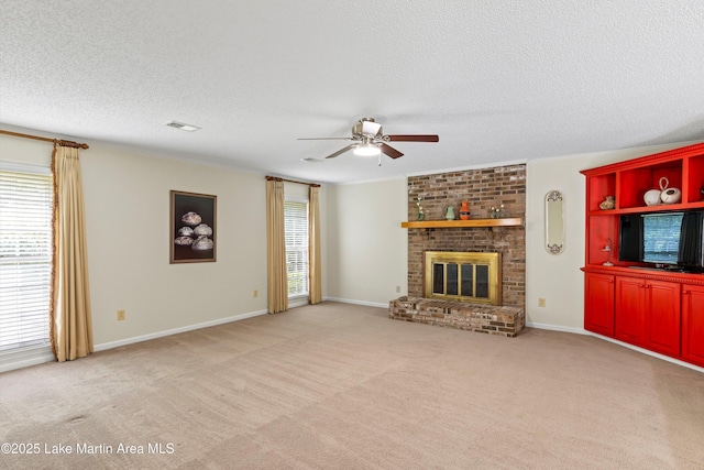 970 Raintree Dr, Alexander City, AL 35010 - unfurnished living room featuring a ceiling fan, a textured ceiling, a brick fireplace, light colored carpet, and crown molding