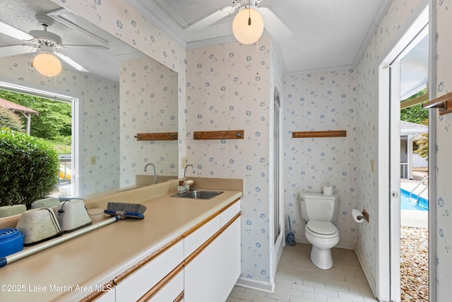 970 Raintree Dr, Alexander City, AL 35010 - bathroom with ceiling fan, wallpapered walls, crown molding, tile patterned flooring, and vanity