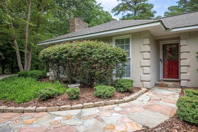 970 Raintree Dr, Alexander City, AL 35010 - property entrance with a chimney, roof with shingles, and stucco siding
