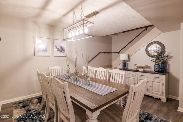 dining area featuring dark hardwood / wood-style flooring and a textured ceiling