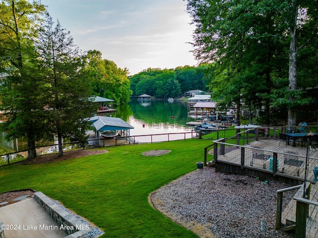 view of yard featuring a dock and a water view