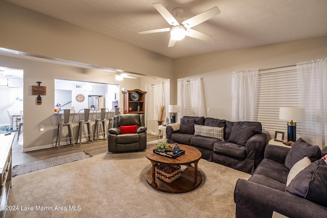 living room featuring hardwood / wood-style flooring and ceiling fan