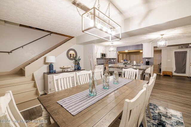 dining space featuring a textured ceiling and dark hardwood / wood-style floors