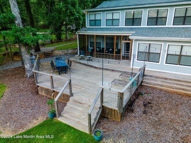 wooden deck featuring a sunroom