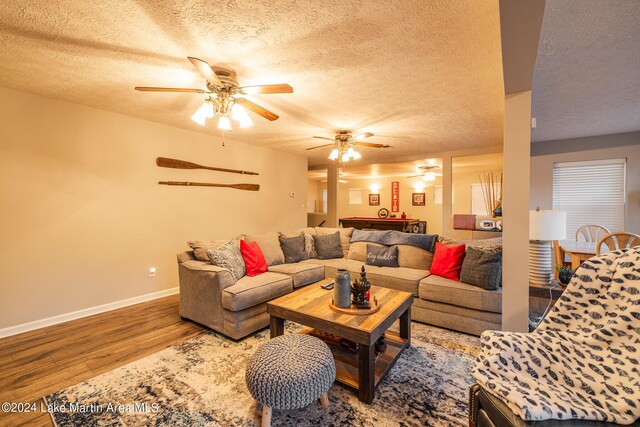 living room with hardwood / wood-style floors, ceiling fan, a textured ceiling, and billiards