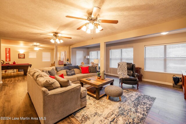 living room with hardwood / wood-style flooring, ceiling fan, a textured ceiling, and pool table