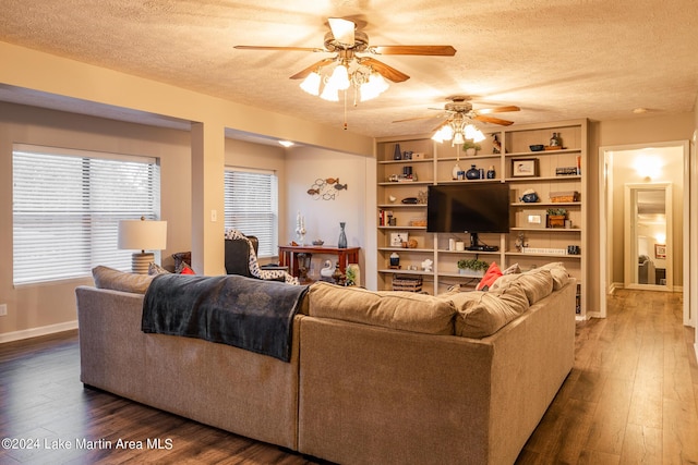 living room featuring a textured ceiling, dark hardwood / wood-style flooring, and ceiling fan