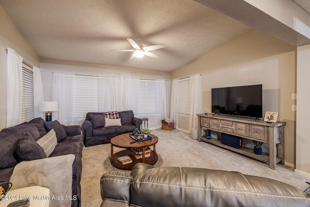 living room featuring a textured ceiling, ceiling fan, light carpet, and vaulted ceiling