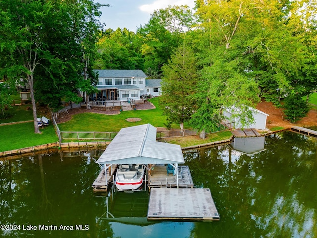 view of dock with a lawn, a patio area, and a water view