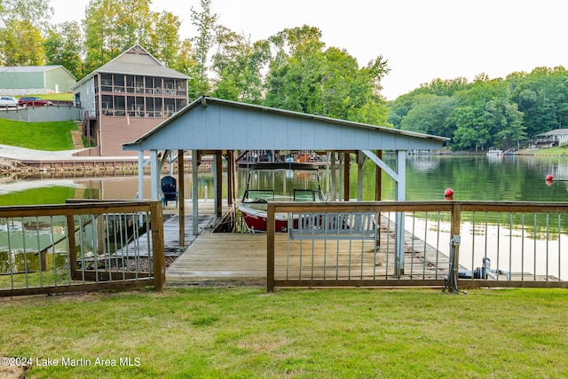 dock area with a lawn and a water view