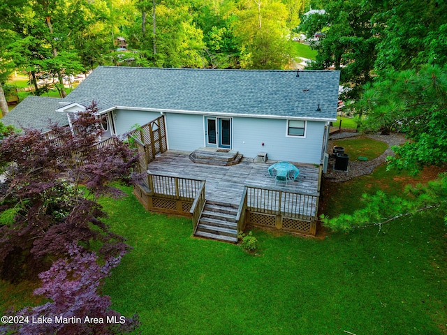 back of property featuring french doors, a yard, cooling unit, and a wooden deck