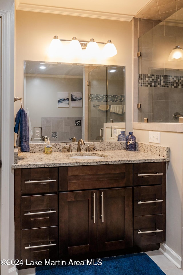 bathroom with vanity, an enclosed shower, and ornamental molding