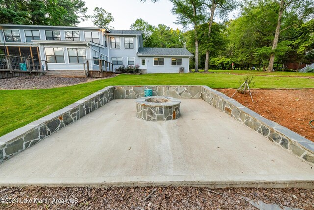 view of patio / terrace featuring a sunroom and an outdoor fire pit