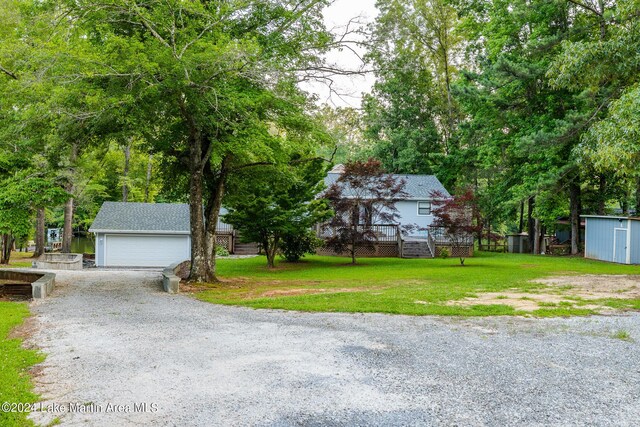 view of yard with a garage and a storage unit