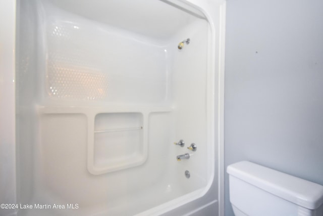 bathroom featuring bathing tub / shower combination and toilet