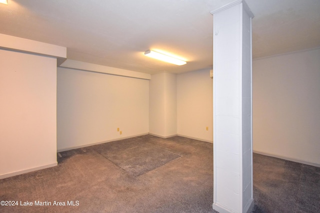 basement featuring dark colored carpet