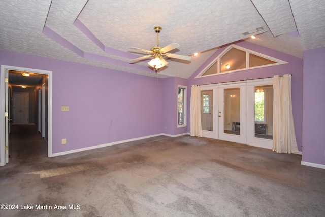 unfurnished living room featuring dark colored carpet, ceiling fan, a textured ceiling, and french doors