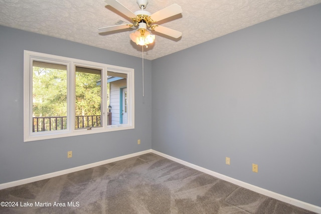 unfurnished room with carpet, ceiling fan, and a textured ceiling