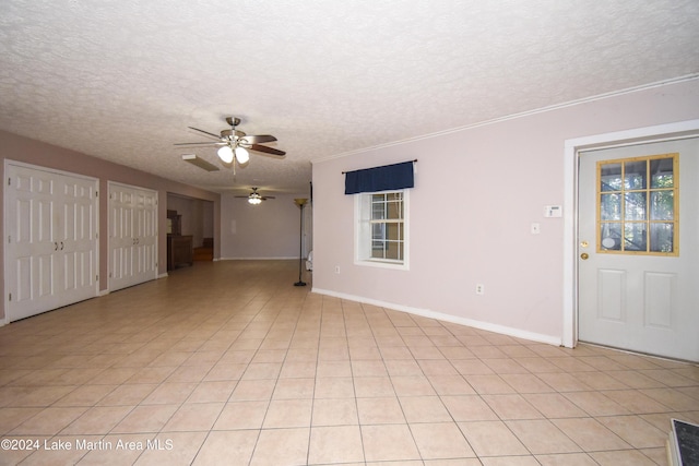 tiled spare room featuring ceiling fan and a textured ceiling