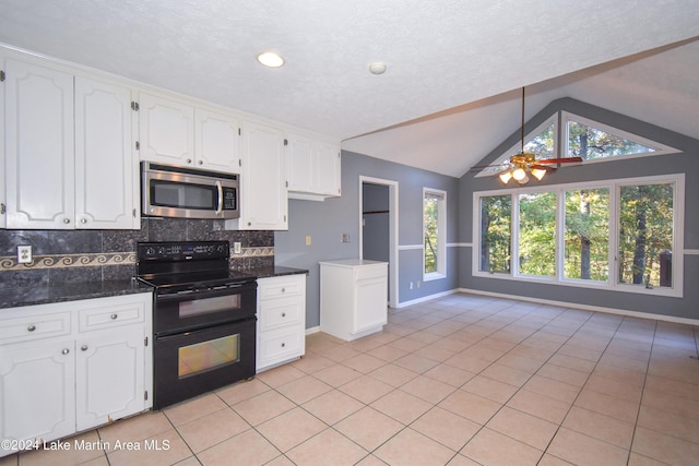 kitchen with lofted ceiling, white cabinetry, black range with electric stovetop, and ceiling fan