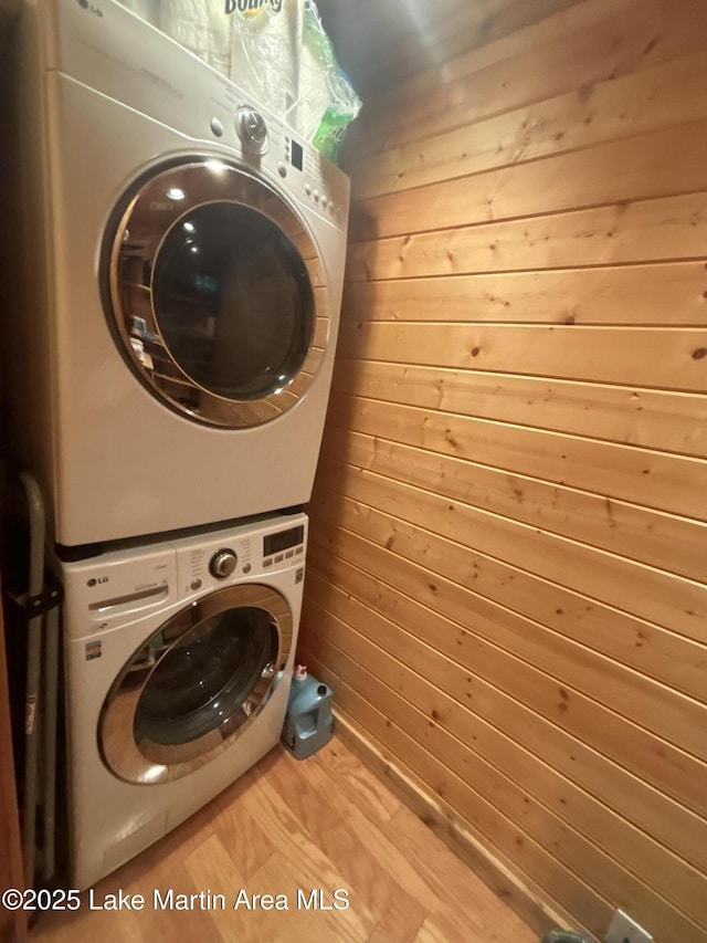151 Pemberton Rd, Tallassee, AL 36078 - laundry room featuring stacked washer and clothes dryer, wooden walls, and wood finished floors