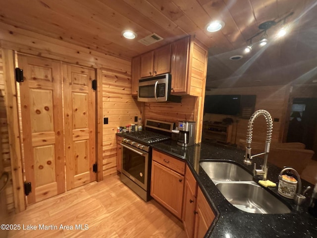 151 Pemberton Rd, Tallassee, AL 36078 - kitchen featuring stainless steel appliances, a sink, light wood-style floors, wooden ceiling, and wood walls
