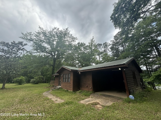 151 Pemberton Rd, Tallassee, AL 36078 - view of home's exterior with a yard and metal roof