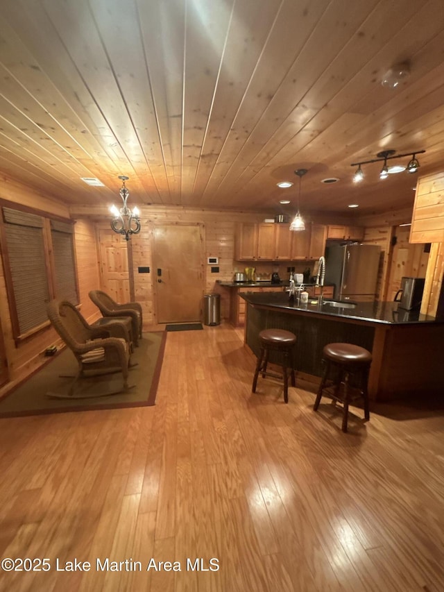 151 Pemberton Rd, Tallassee, AL 36078 - living area featuring wood ceiling, light wood-type flooring, and a chandelier