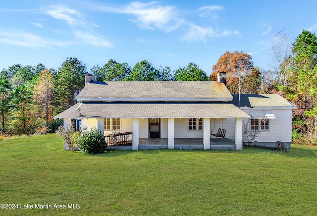 back of property featuring a patio area and a yard