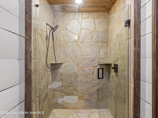 bathroom featuring a shower with door