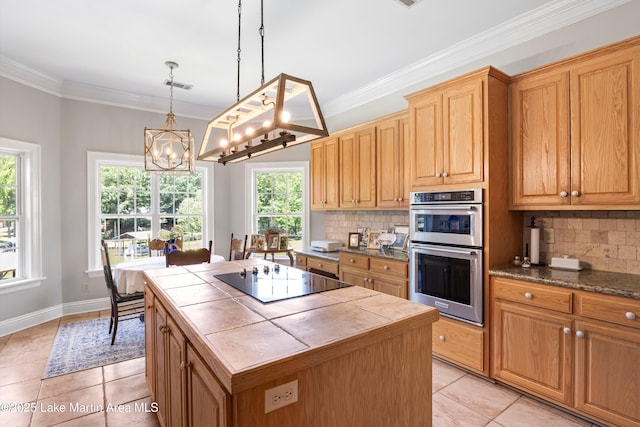 314 Daine Dr, Jacksons Gap, AL 36861 - kitchen featuring black electric cooktop, stainless steel double oven, tile countertops, backsplash, and a chandelier
