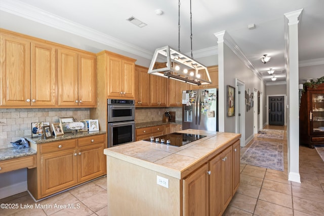 314 Daine Dr, Jacksons Gap, AL 36861 - kitchen featuring stainless steel appliances, decorative backsplash, a center island, light tile patterned floors, and crown molding