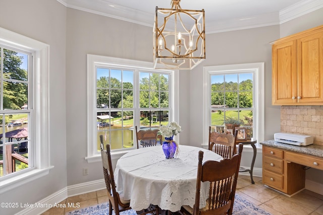 314 Daine Dr, Jacksons Gap, AL 36861 - dining space featuring a chandelier, healthy amount of natural light, light tile patterned floors, and ornamental molding