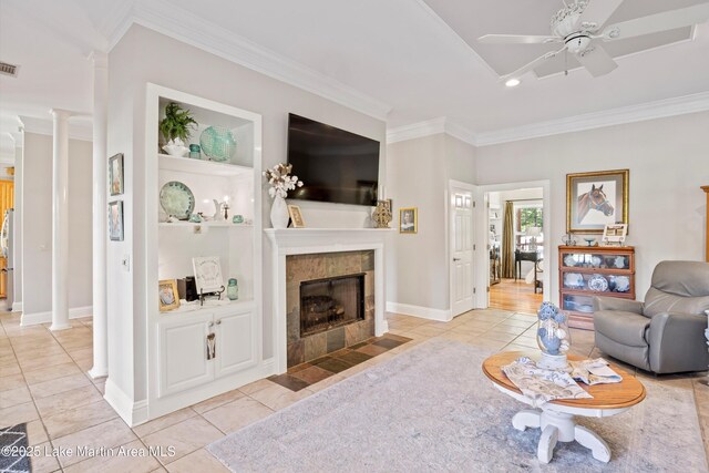 314 Daine Dr, Jacksons Gap, AL 36861 - living area with crown molding, decorative columns, a ceiling fan, a fireplace, and light tile patterned floors