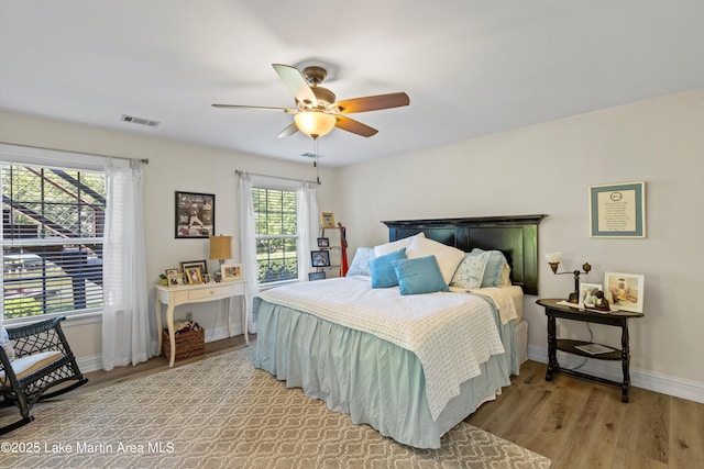 314 Daine Dr, Jacksons Gap, AL 36861 - bedroom with baseboards, light wood-style flooring, and ceiling fan