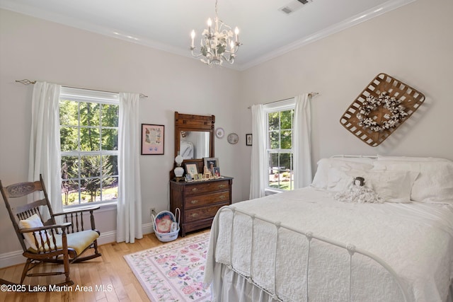 314 Daine Dr, Jacksons Gap, AL 36861 - bedroom featuring light wood-style flooring, a chandelier, baseboards, and crown molding