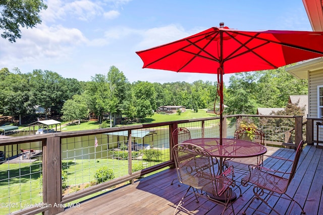 314 Daine Dr, Jacksons Gap, AL 36861 - deck with outdoor dining space, a yard, and view of scattered trees