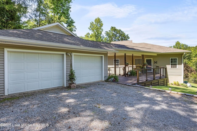 314 Daine Dr, Jacksons Gap, AL 36861 - ranch-style house with gravel driveway, an attached garage, a shingled roof, and covered porch