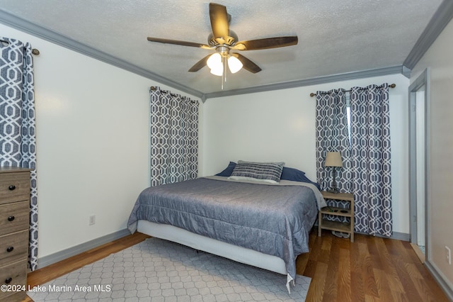 bedroom featuring ornamental molding, a textured ceiling, ceiling fan, and dark wood-type flooring