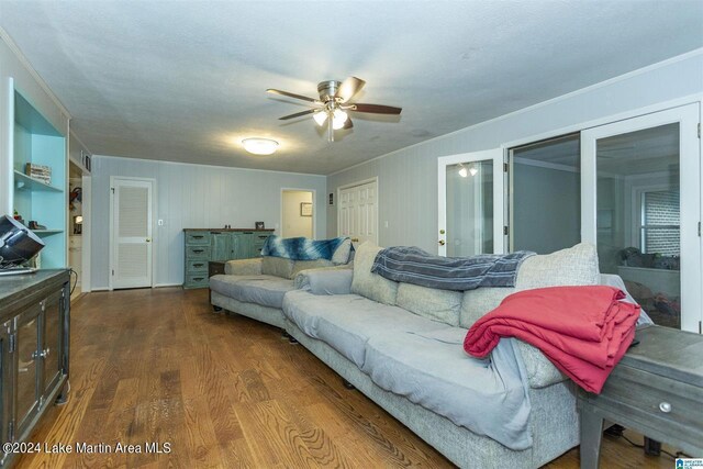 living room featuring ceiling fan, french doors, hardwood / wood-style floors, a textured ceiling, and ornamental molding