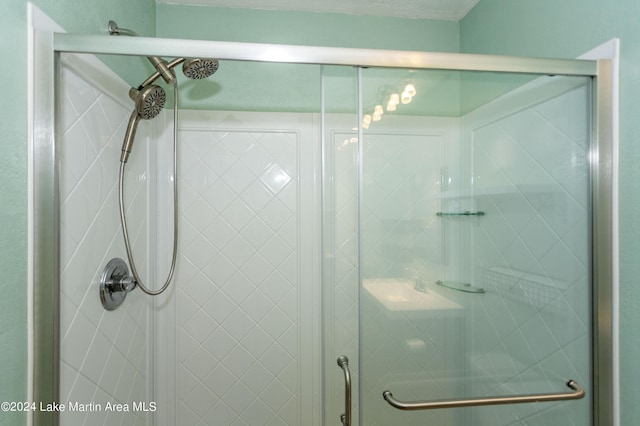 bathroom with a shower with door