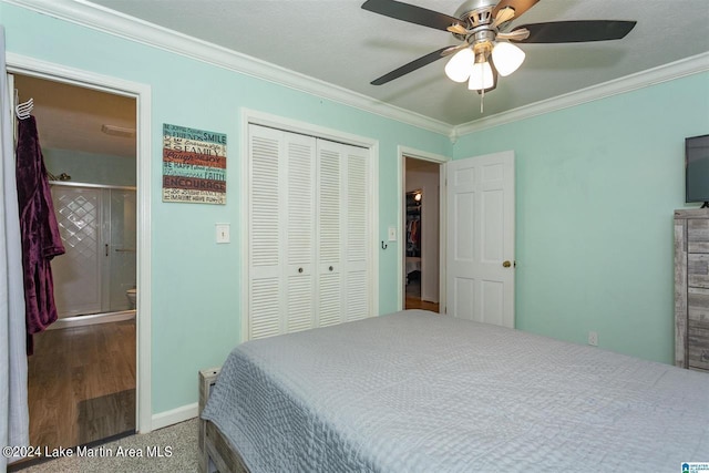 bedroom with carpet floors, a closet, ceiling fan, and ornamental molding