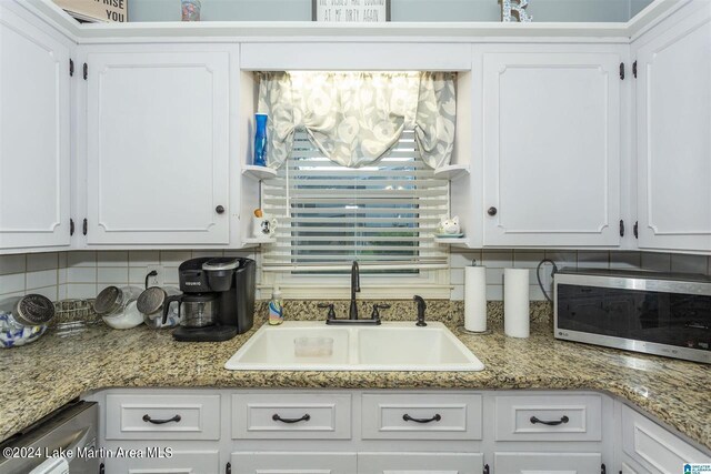 kitchen with white cabinetry and sink