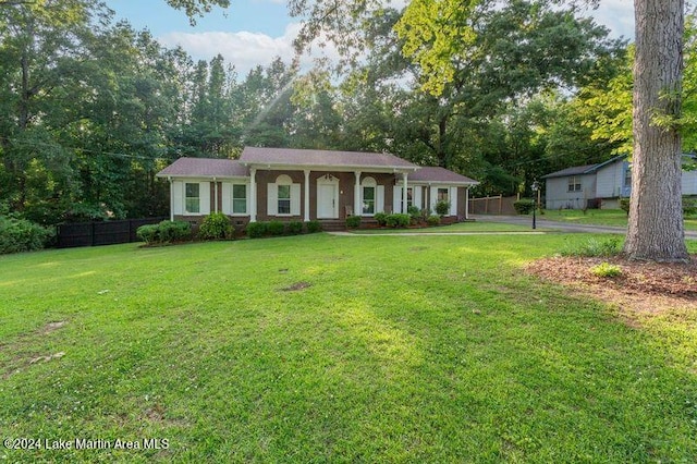 ranch-style home with a front lawn