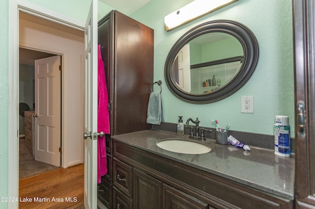 bathroom with hardwood / wood-style floors and vanity