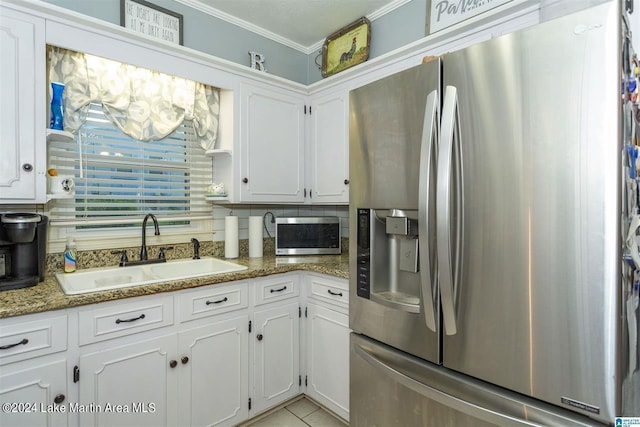 kitchen featuring sink, white cabinets, stainless steel appliances, and stone countertops