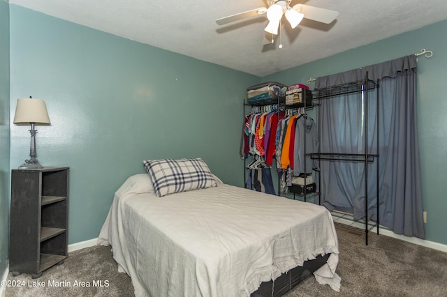 carpeted bedroom featuring a textured ceiling and ceiling fan