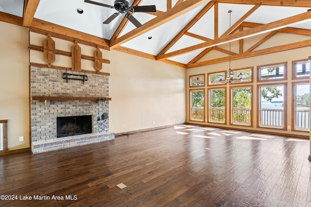 unfurnished living room featuring hardwood / wood-style flooring, ceiling fan with notable chandelier, and baseboards